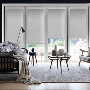 Marco Cinder grey perfect fit roller blind in patio door frame with contemporary furniture and grey accessories