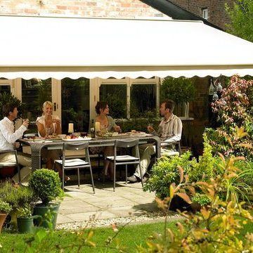 Plain Cream Awning with scalloped hem shading a group of people eating on the patio