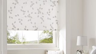 Patterned Seedhead White roller blind hung in bedroom