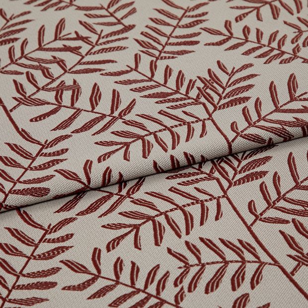 A folded piece of fabric with Fronds Beetroot Red printed on it