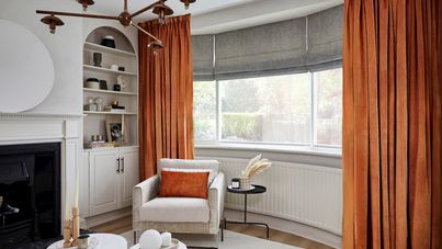 Darcia velvet cointreau floor length curtains paired with grey roman blinds in living room
