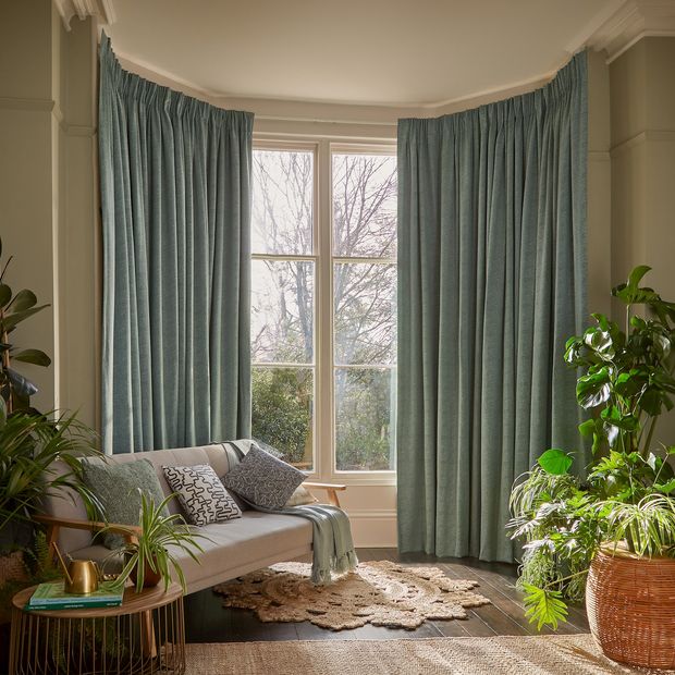 Spritz elm floor length pinch pleat curtains in living room full of greenery
