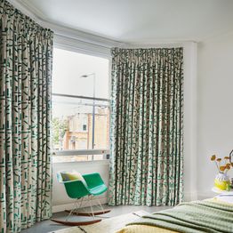 mori evergreen floor length curtains on bay window in living room