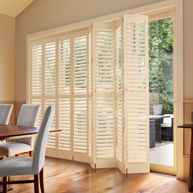 cream tracked full height shutters on patio doors in kitchen/dining area