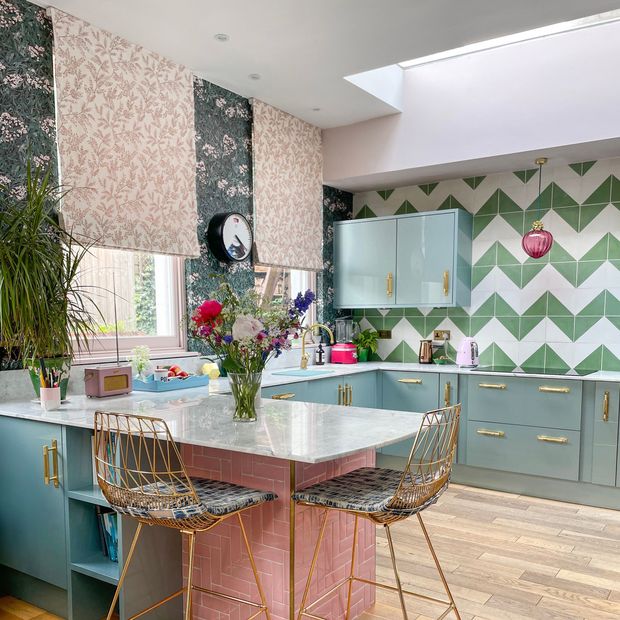 pink floral roman blind and curtain in kitchen/living area with floral patterned walls and furnishings