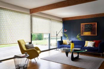 set of three green/yellow patterned roller blinds on wide sliding patio doors in living room