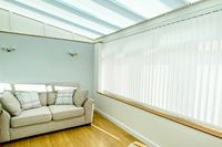 white vertical blinds on long conservatory window