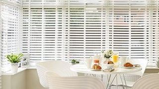 Matte White Wood Illusion Blind in Conservatory with Dining Table and Chairs