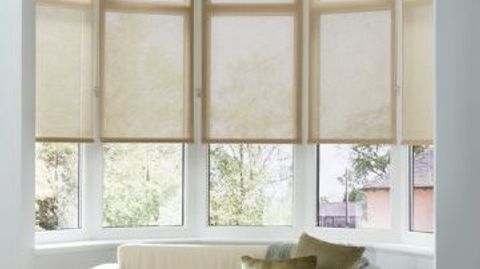Plain light Tatum Beige roller blinds hung in living room