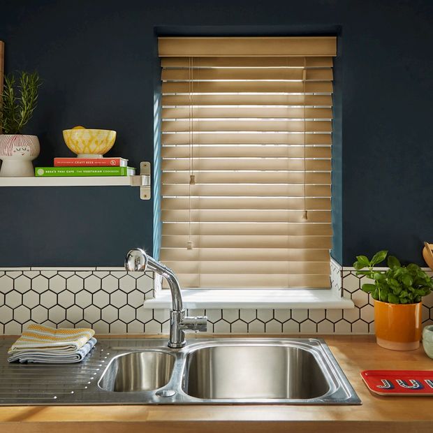 navy kitchen with colourful accessories featuring wooden venetian blind