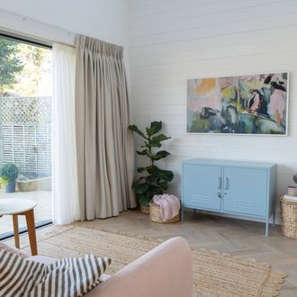 kendra-linen-pencil-pleat-curtains-over-bi-fold-doors-in-a-living-room