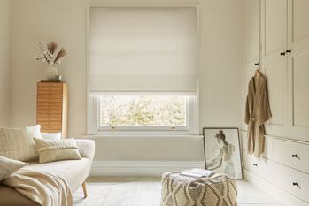 textured white roman blind in neutral dressing room