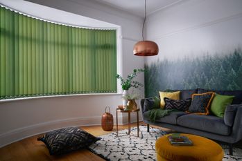 Green vertical blinds shading living room with nature theme