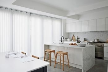 Alma white vertical blinds covering large glass kitchen doors