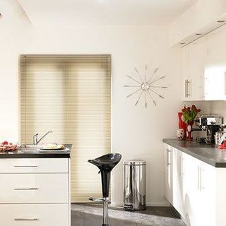 Light wood Aluwood Elderberry Venetian blinds hung in a modern kitchen