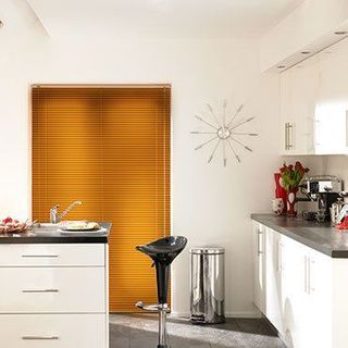 Rich wood Aluwood Hornwood Venetian blinds hung in a modern kitchen