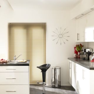 Light wood Aluwood Scottish Pine Venetian blinds hung in a modern kitchen