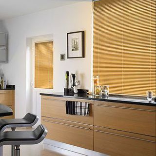 Light wood Aluwood Sugar Maple Venetian blinds in a kitchen