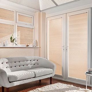 Light Portfolio Melon Venetian blinds hanging in patio doors