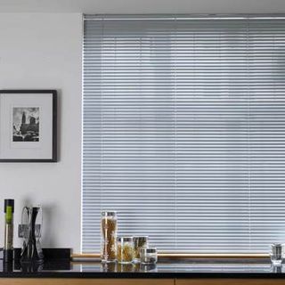 Portfolio Mid Grey Venetian blinds hung in a kitchen window