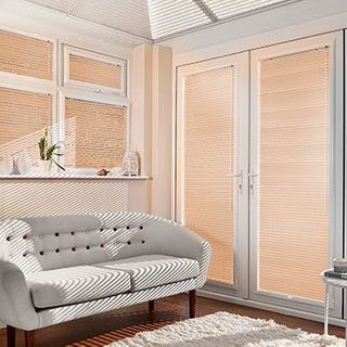 Light Portfolio Mellow Peach Venetian blinds hanging in patio doors