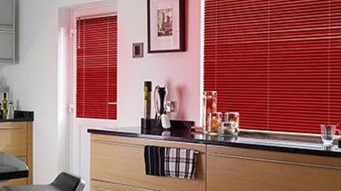 Red Portfolio Scarlet Venetian blinds hanging in a modern kitchen