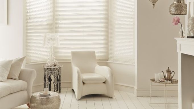 Cream Wooden blinds used in a living room to control light