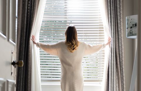 Lifestyle shot bedroom featuring Wooden blind with curtains