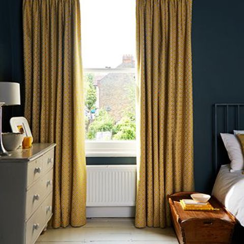 Bedroom window dressed with Eclipse Mimosa Yellow Curtains