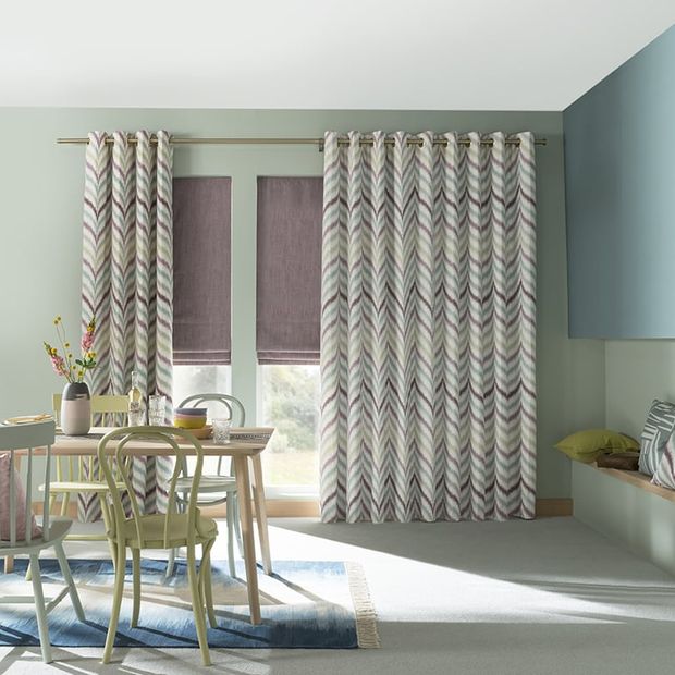 Colourful Dining Room with large windows dressed with Eyelet kitchen Curtains and soft pink roman blinds