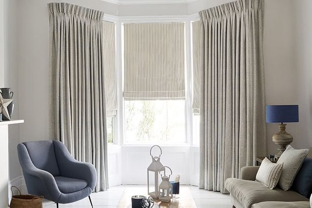 Modern minimalist living room with full length silver curtains