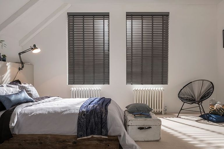 grey faux wooden venetian blinds in a minimalist bedroom window