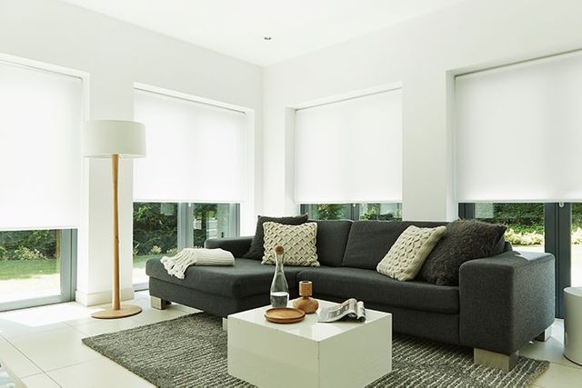 bright white roller blinds in a contemporary styled living room 