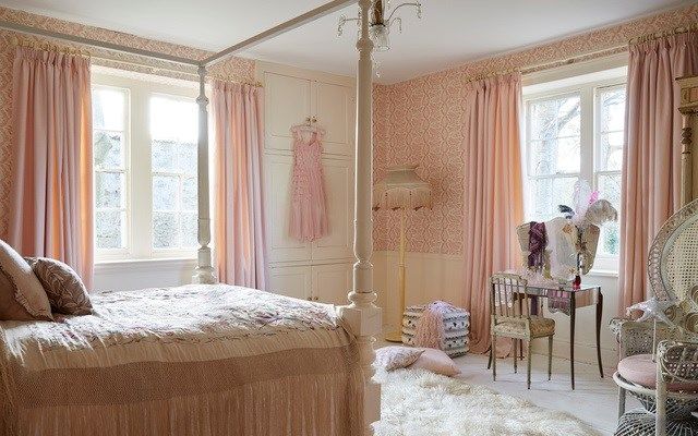 pink curtains fitted to rectangular windows in a bedroom decorated in white and pink