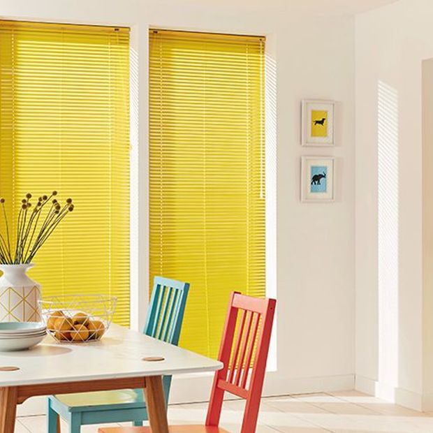 light and bright dining room with yellow venetian blinds
