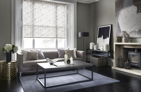 Formal living room with a grey floral roller blind