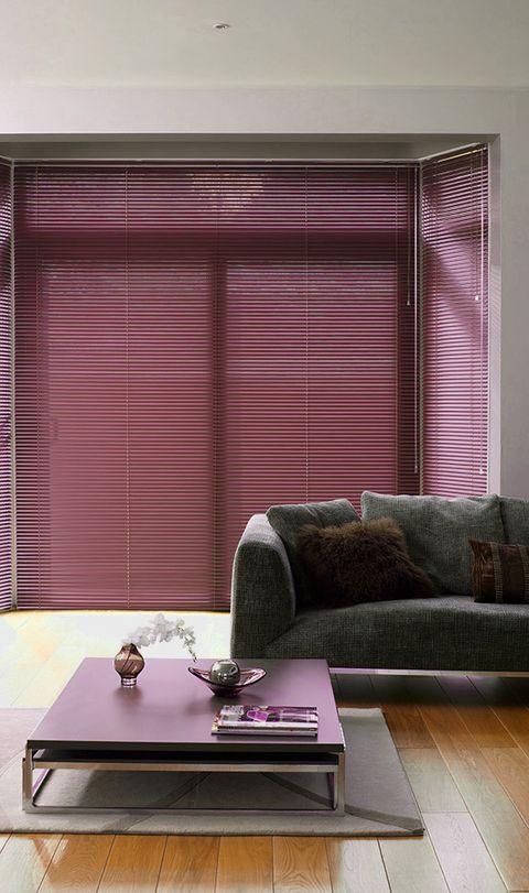 Close up of a window featuring a damson coloured Venetian blind