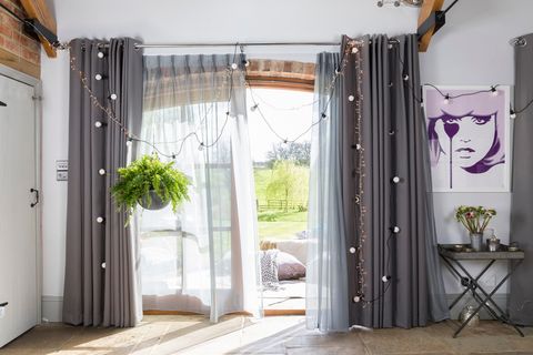 Jo Wiley collaboration Hillarys grey curtains in a large patio window 
