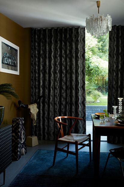 Dark and Edgy Dining Area with Black Pattern Wave Curtains in Cadillac Noir Fabric from the Abigail Ahern Collection