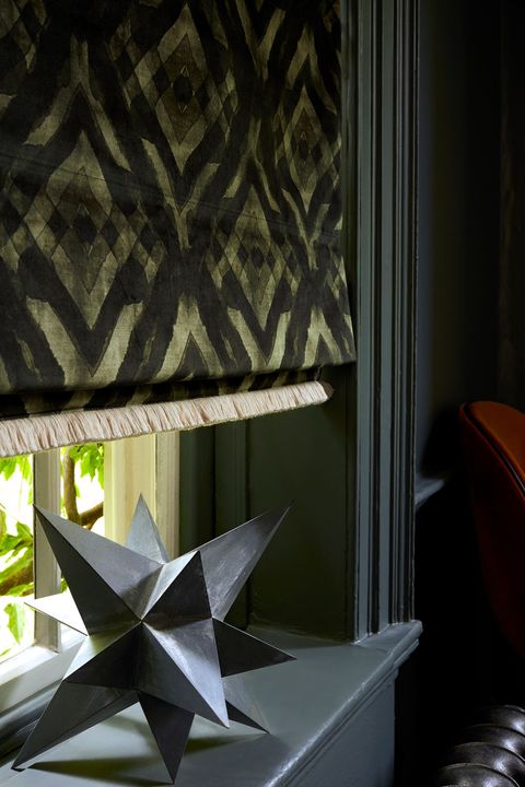 Close up of Abigail Ahern dark green patterned roman blinds in luxurious velvet fabric