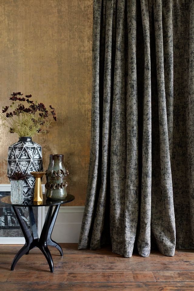 Edgy room with side table and accessories next to a Dark Grey Curtains in Garcia Phantom fabric