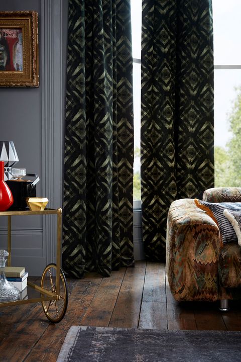 Dark and Eccentric Living Room Decorated with Green and Black velvet curtains from the Abigail Ahern collection