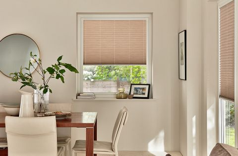 Modern dining room with windows dressed with taupe perfect fit blinds 
