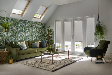 Living room with tropical design and patio doors dressed with grey perfect fit blinds
