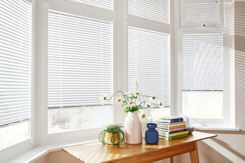 Modern bay window with white perfect fit blinds