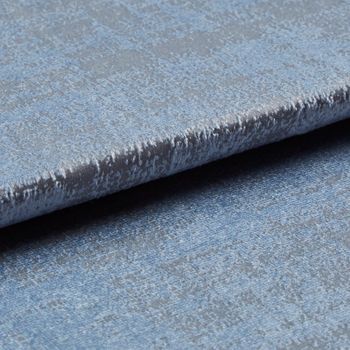 Folded grey coloured fabric layered with light blue in a textured appearance