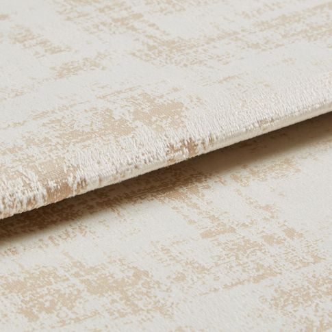 Cream coloured material with dark shades that repeat in a textured style