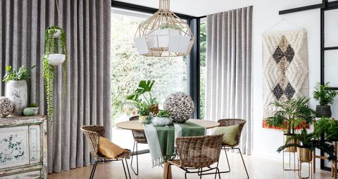 Grey wave header curtains over a patio door in a contemporary dining room 