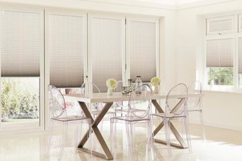 Dining room with perfect fit grey studio pleated blinds on doors and windows