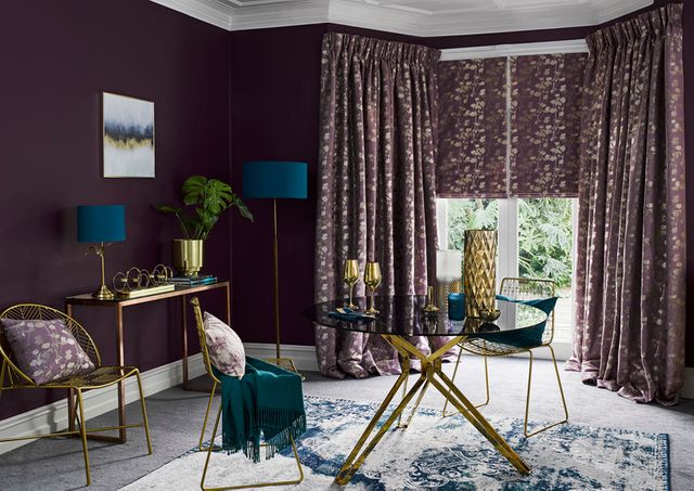 Stylish Lavender curtains and Roman blinds hung in the window of a luxurious living room